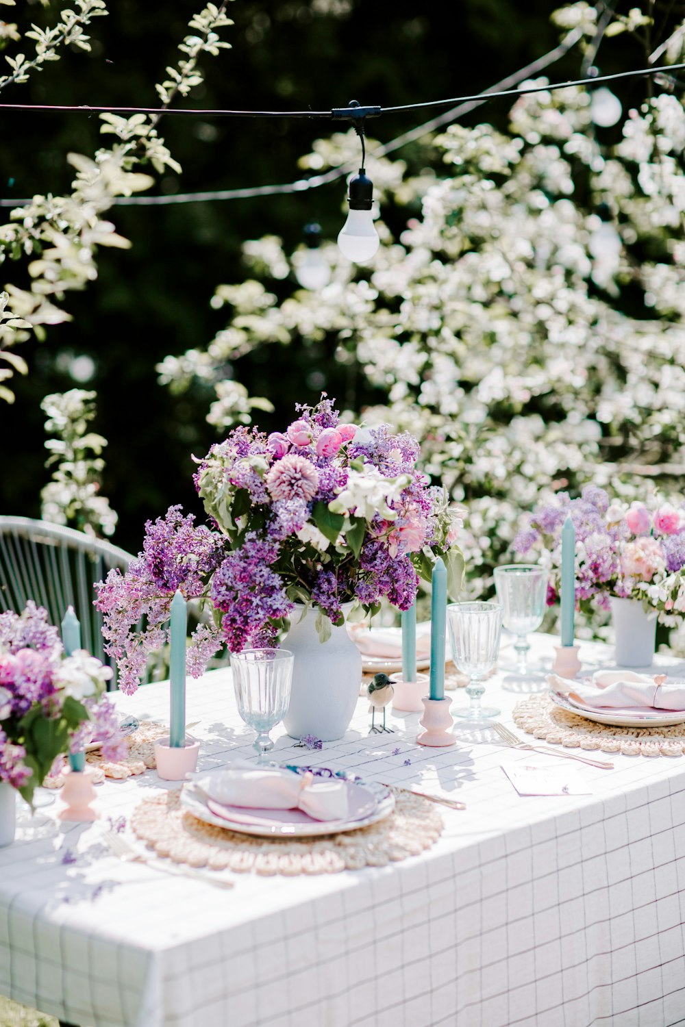 a table with flowers and candles