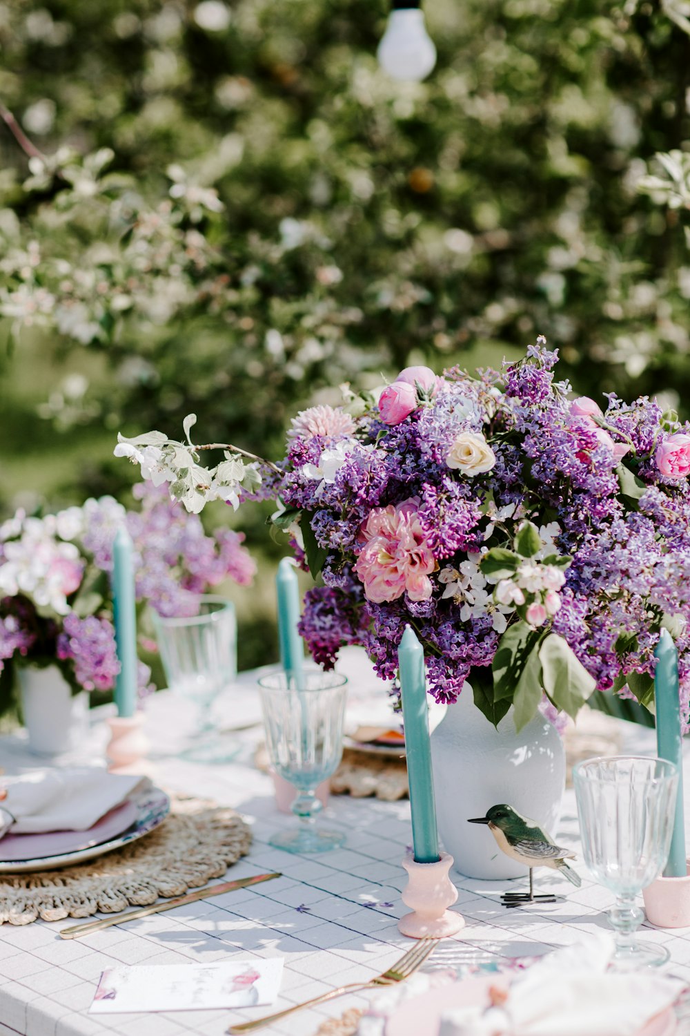 a table with flowers and glasses