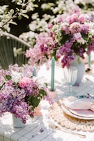 A detailed shot of organic floral arrangements and reusable tableware at a sophisticated event.