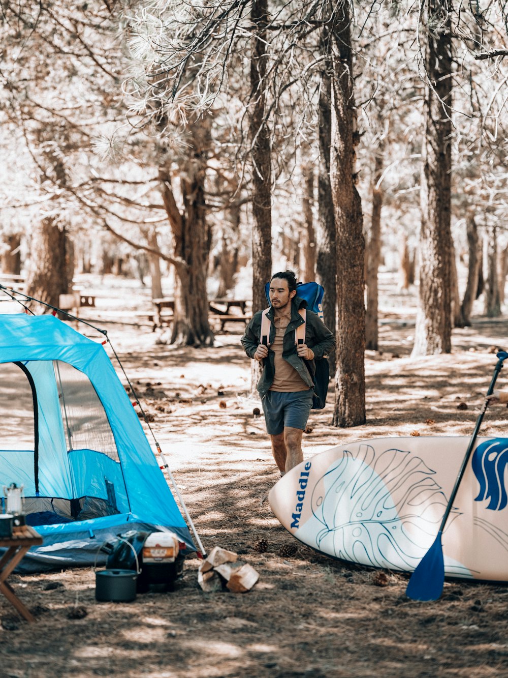 a person standing next to a tent