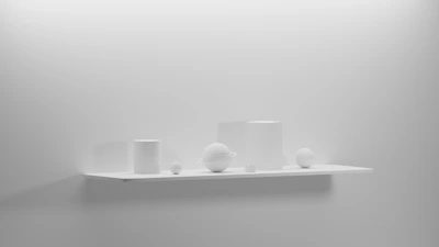 Modern geometric decor pieces displayed on a clean white shelf.
