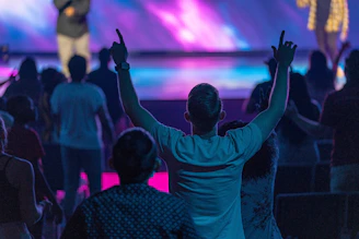 a group of people with their hands up in the air