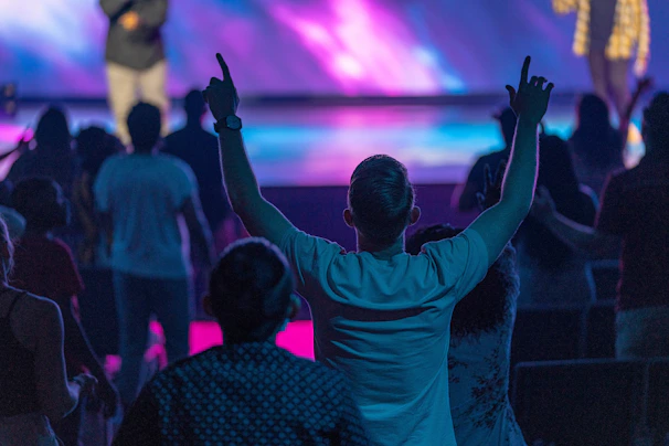 a group of people with their hands up in the air