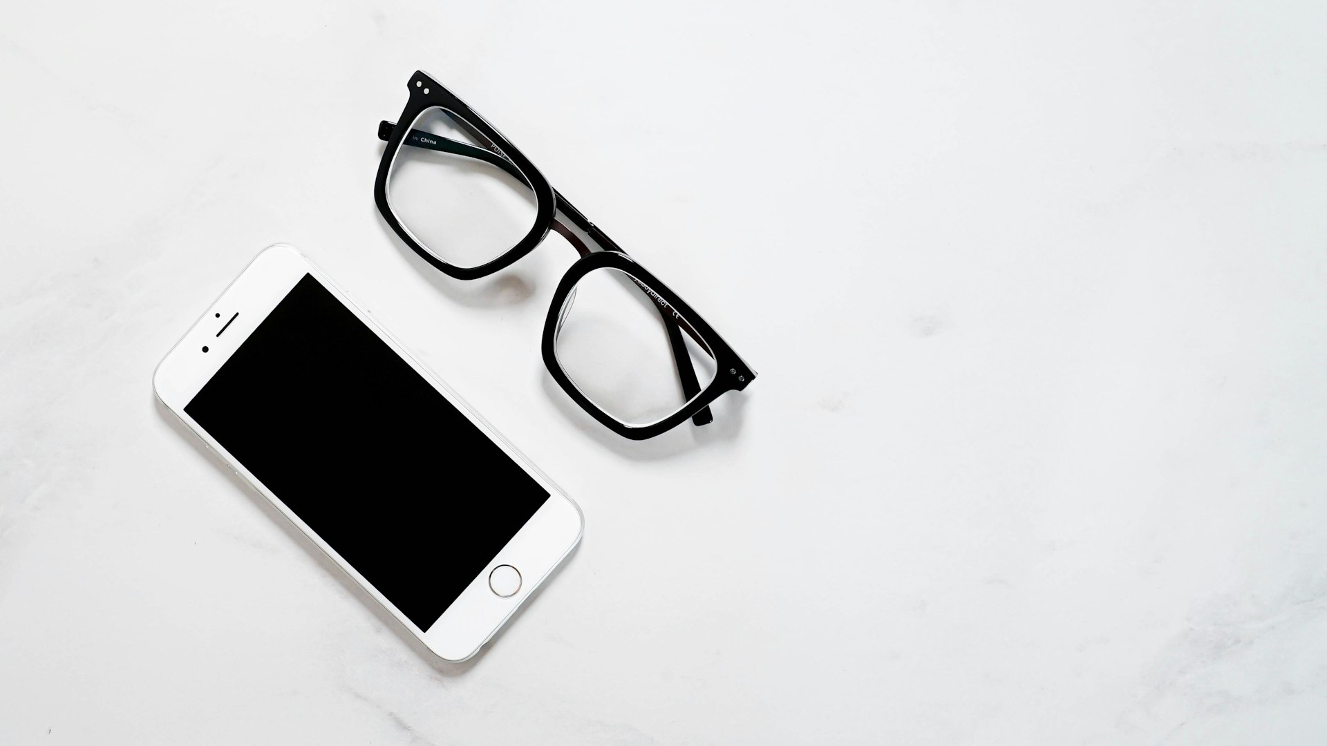 a pair of glasses on a white surface