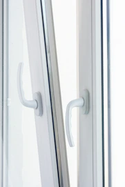 Close-up of robust, bold black handles on industrial-style window frames.