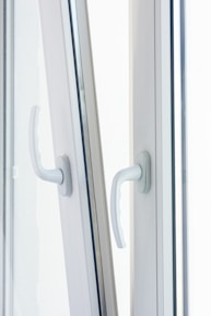 Close-up of robust, bold black handles on industrial-style window frames.
