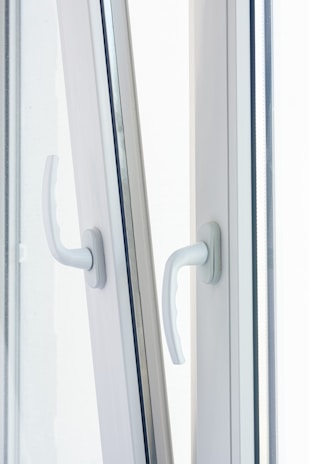 Close-up of a new energy-efficient window locking securely with a modern handle.