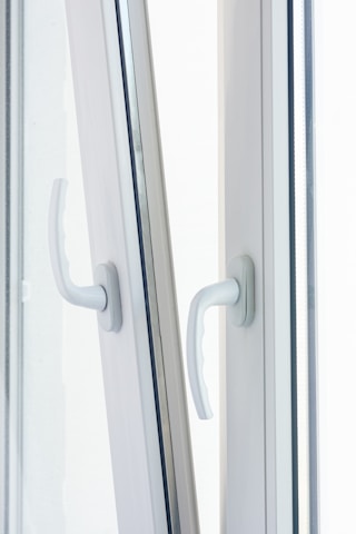 Close-up of robust, bold black handles on industrial-style window frames.