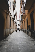 a person walking down a narrow street