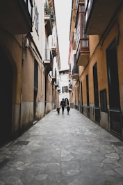 a person walking down a narrow street