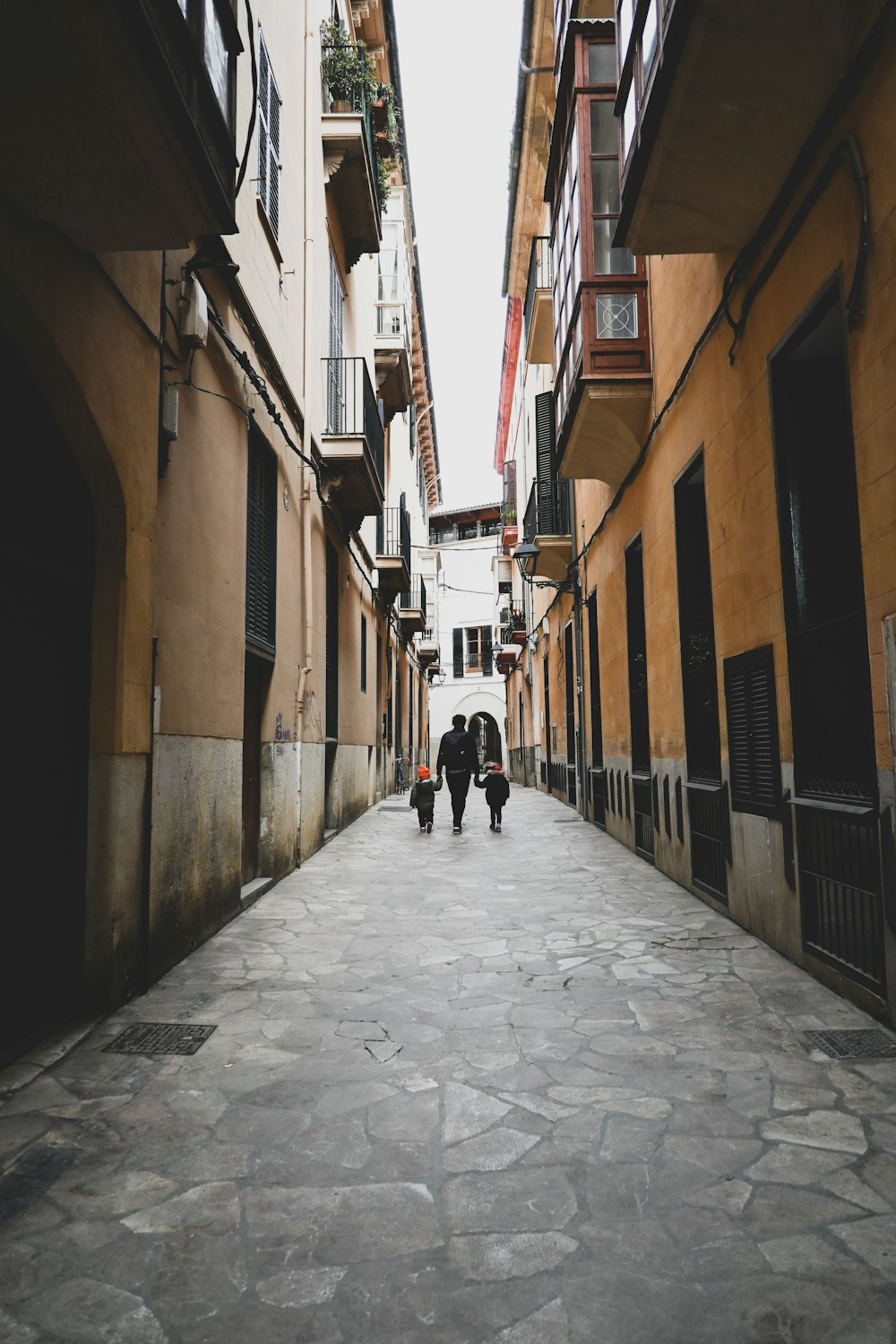 a person walking down a narrow street