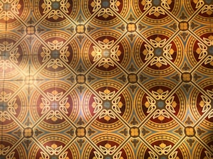 An artistic poster showcasing intricate Indian motifs in warm tones.