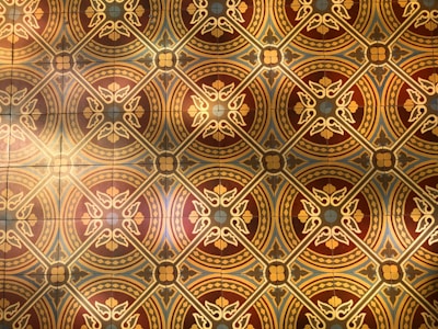 An artistic poster showcasing intricate Indian motifs in warm tones.