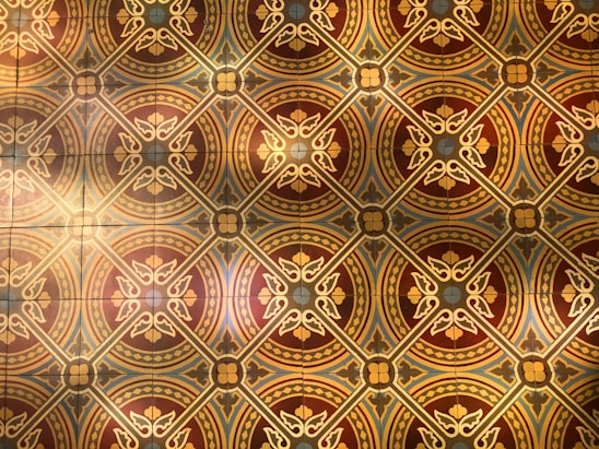 A warm-hued collage featuring ancient manuscripts, royal insignias, and traditional motifs blending into a textured background.