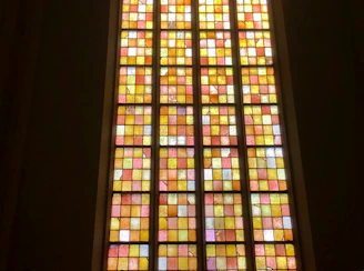 A colorful mosaic window glowing warmly in the evening light.