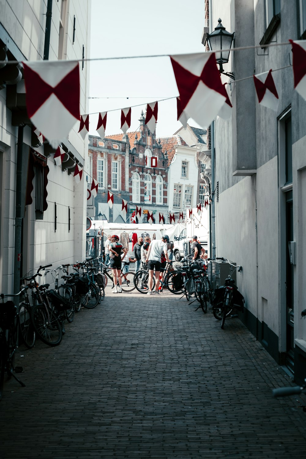 a group of people riding bikes on a brick street