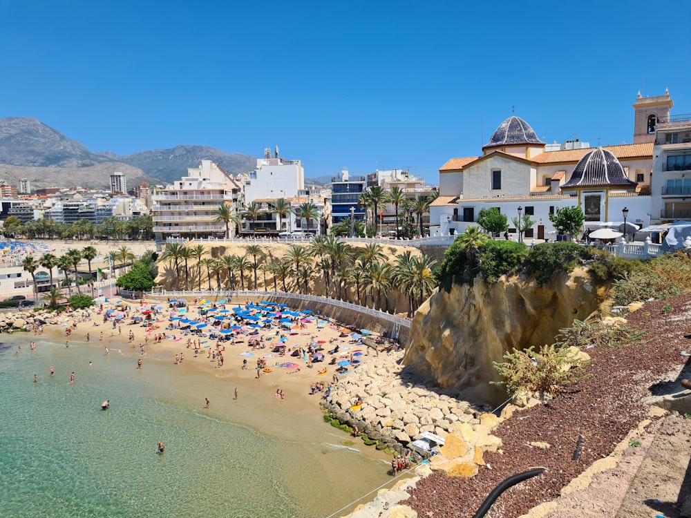 a beach with people and buildings