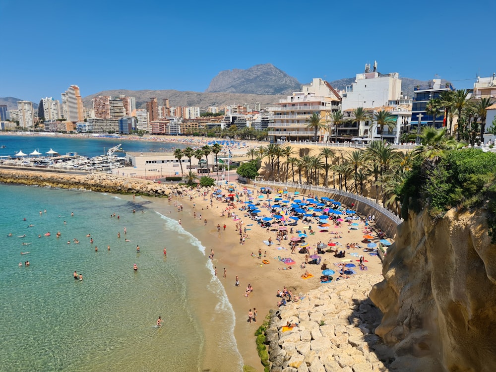 une plage avec des gens et des bâtiments près de lui