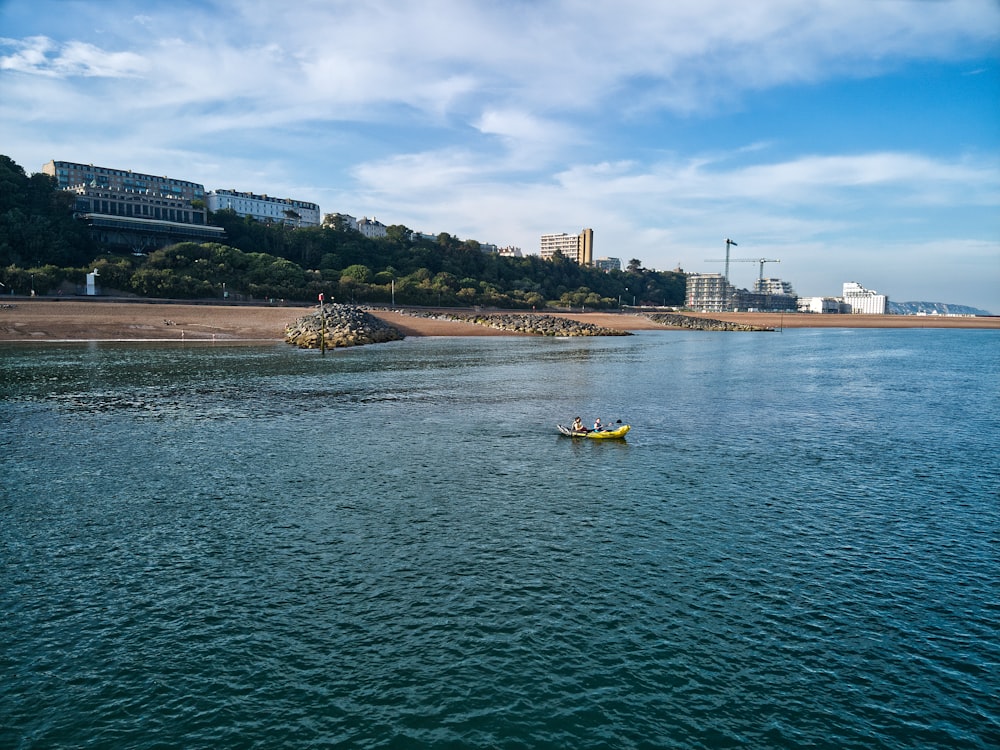 a body of water with boats in it and buildings in the background