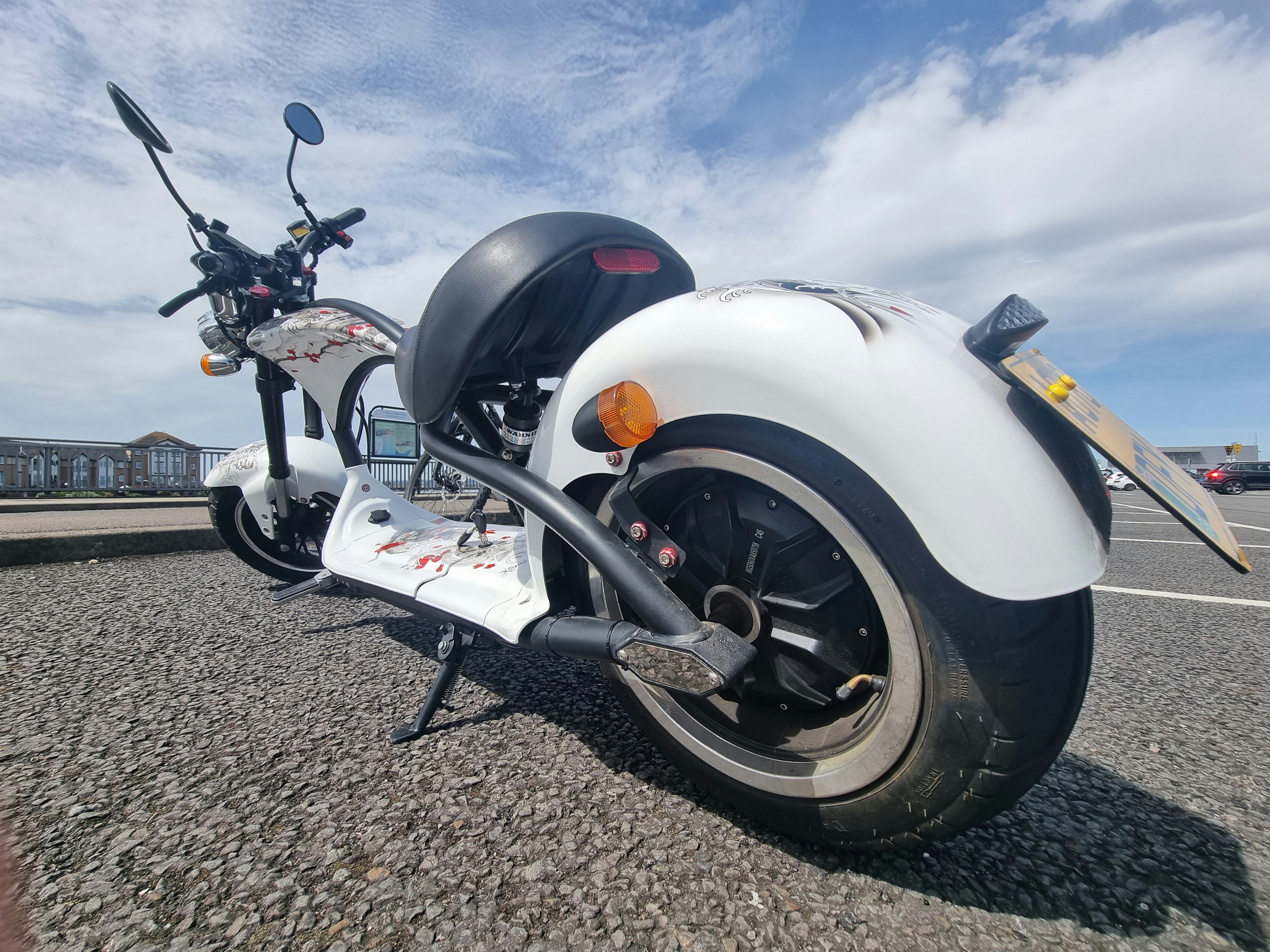 a couple of motorcycles parked on gravel