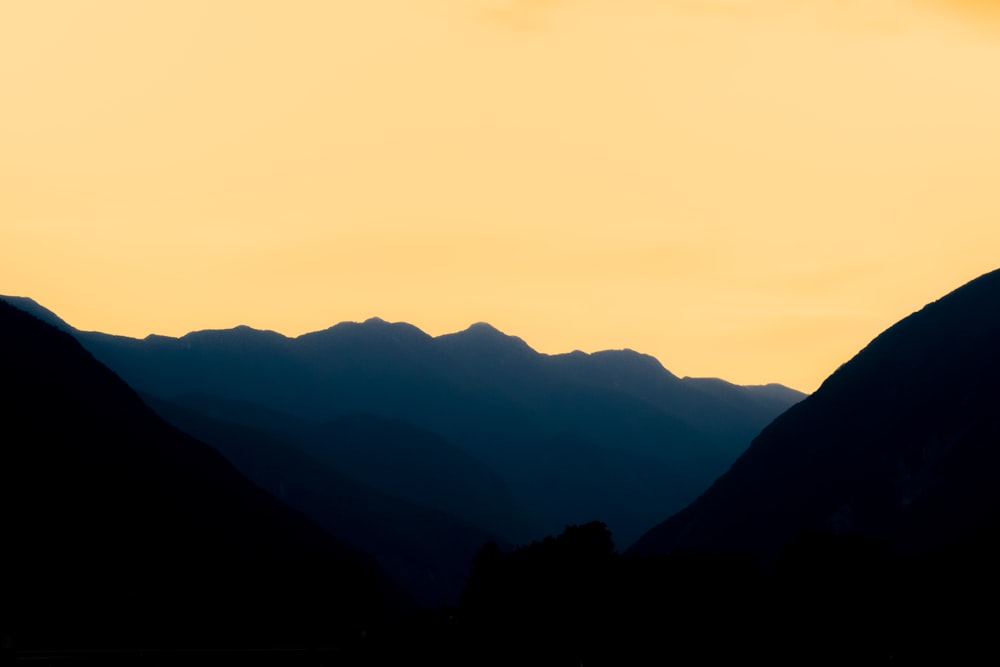 a landscape with hills and a sunset