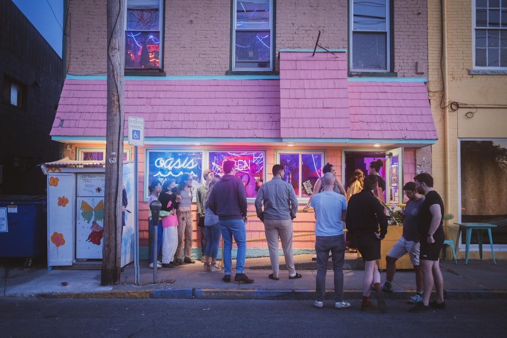 a group of people standing on the sidewalk