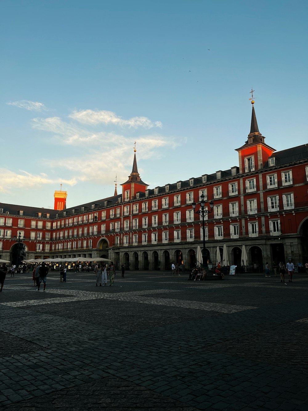 a large building with many windows with Plaza Mayor, Madrid in the background