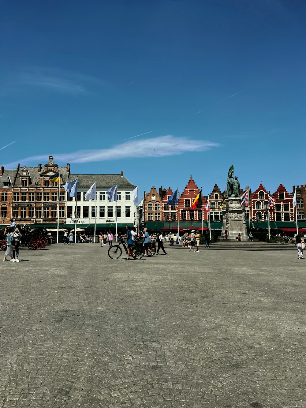 a group of people riding bikes in a town square