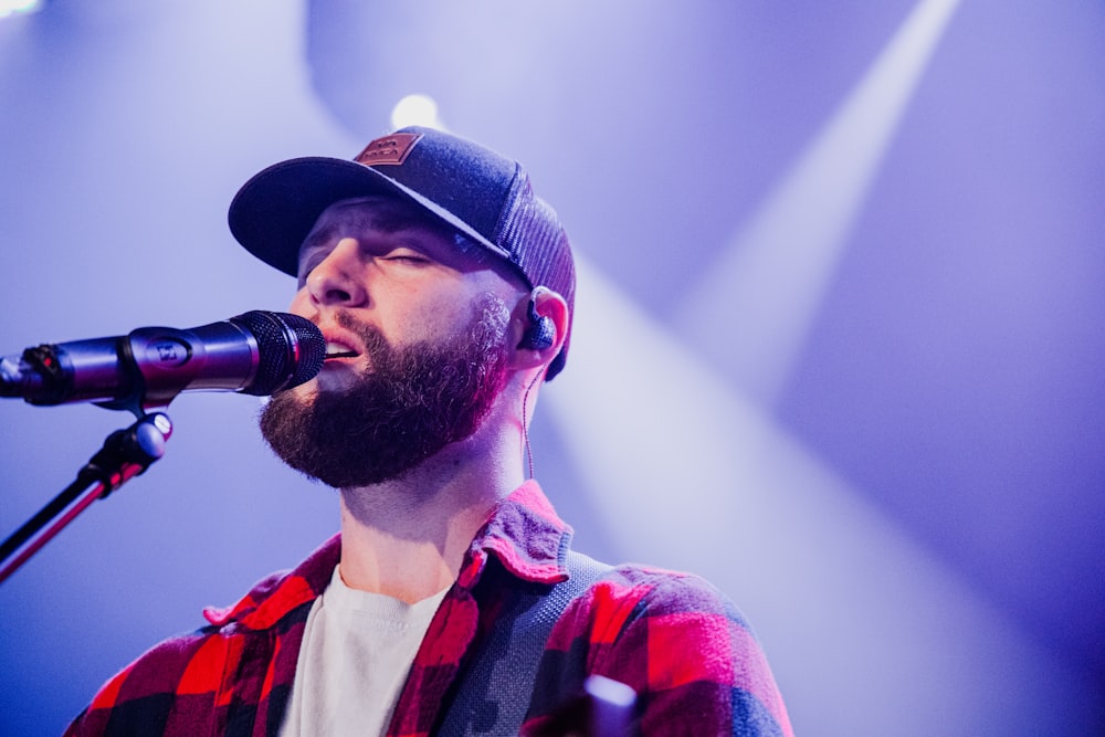 a man with a beard singing into a microphone