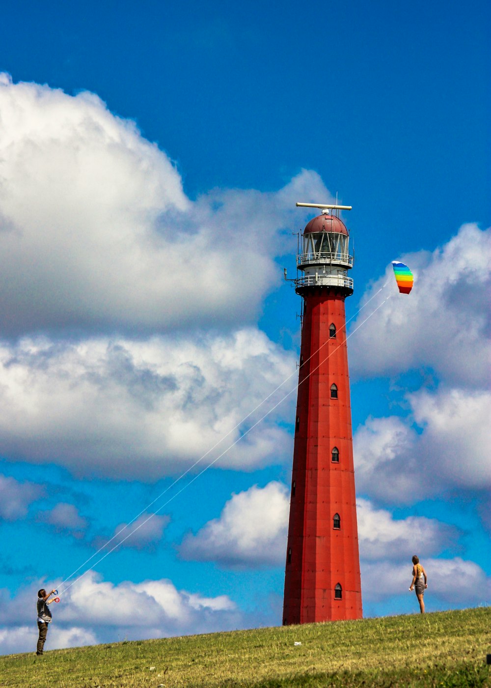 a lighthouse with a kite flying by it