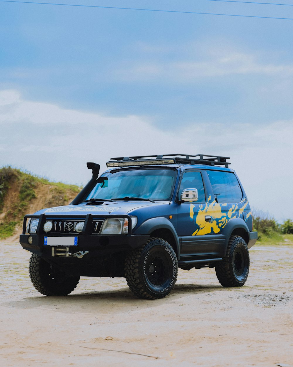 a blue car with a yellow logo