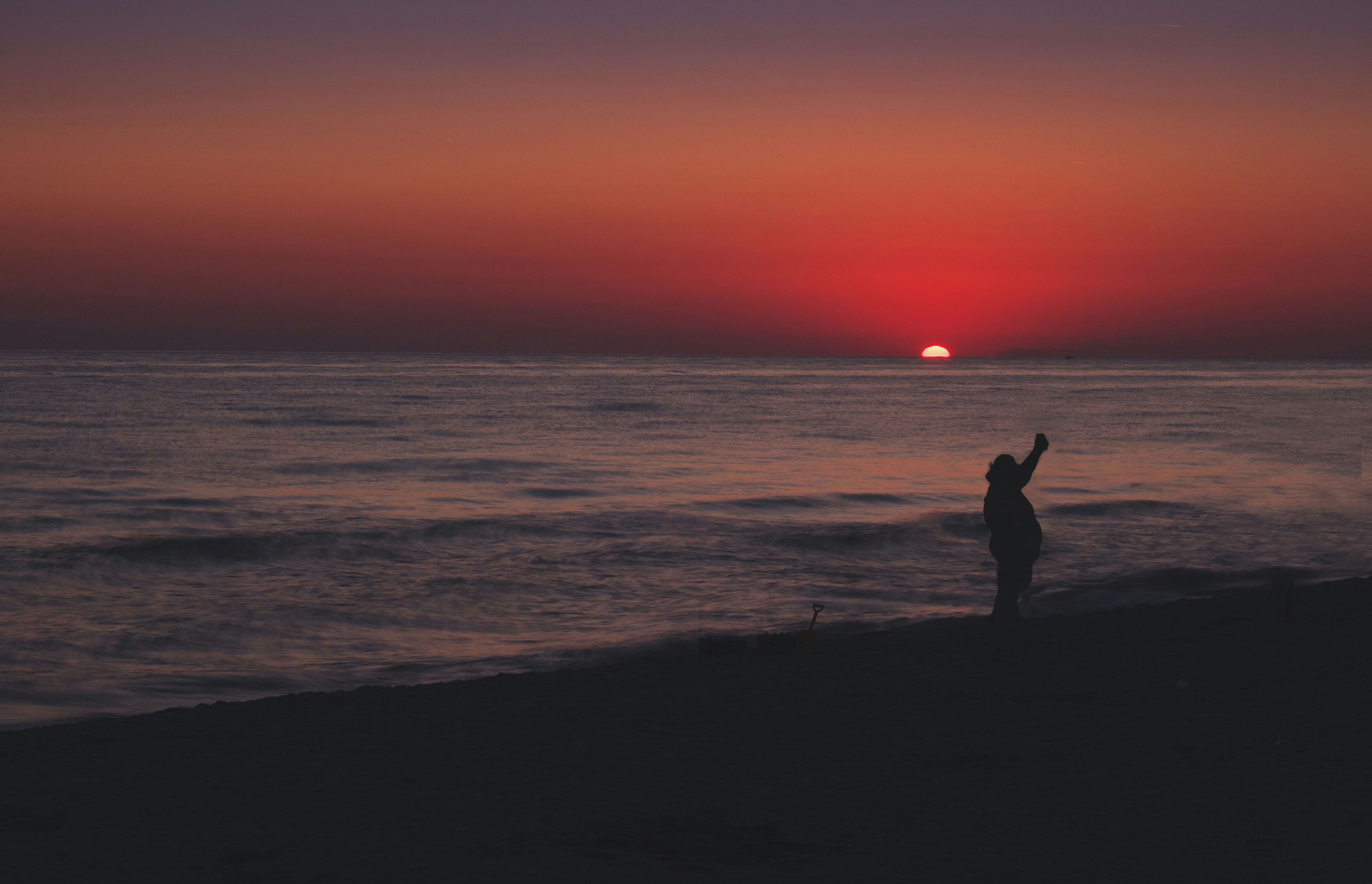 Person standing alone on a beach