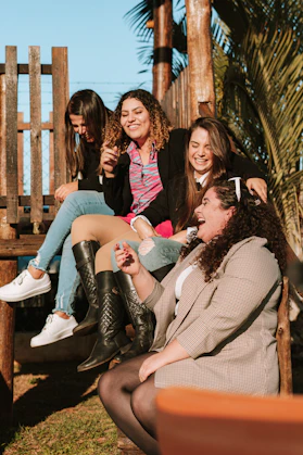 a group of women sitting on a bench