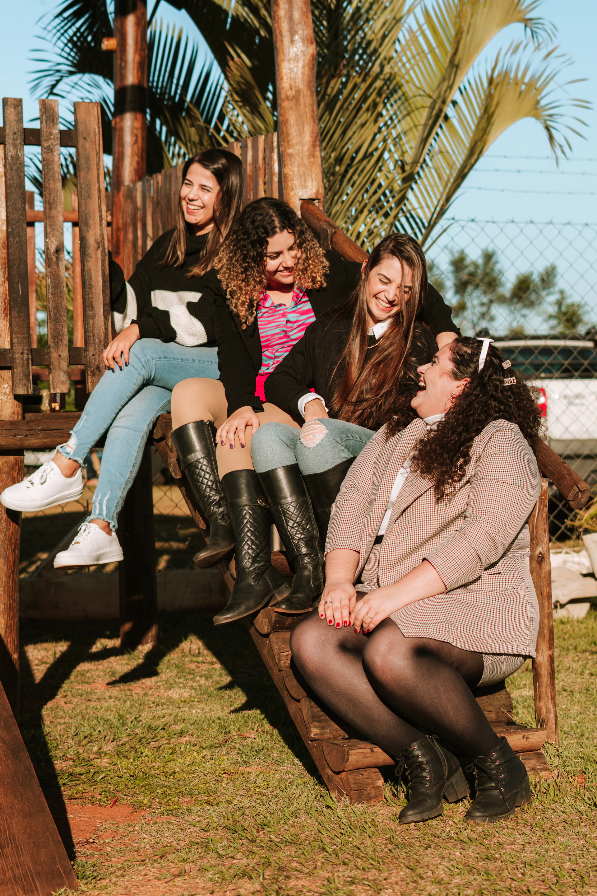 a group of women sitting on a swing