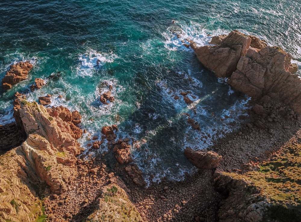 a rocky beach with blue water