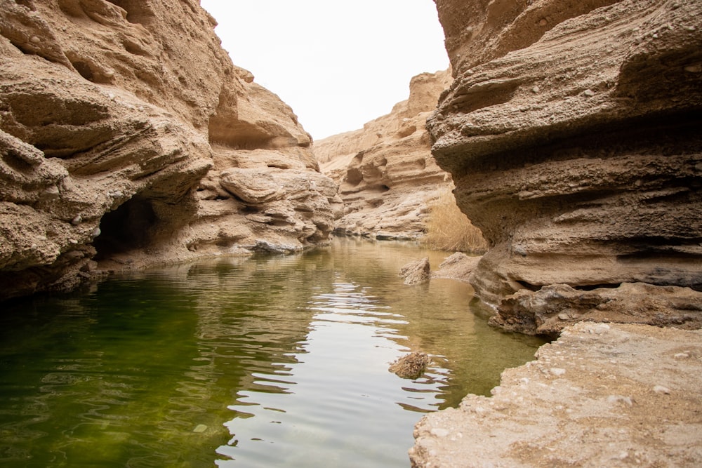 a body of water surrounded by large rocks