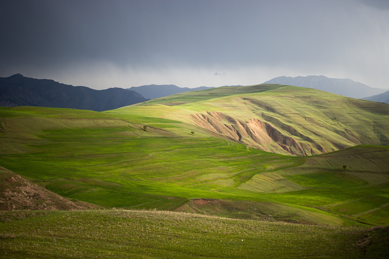 Rolling green hills in a dramatic landscape