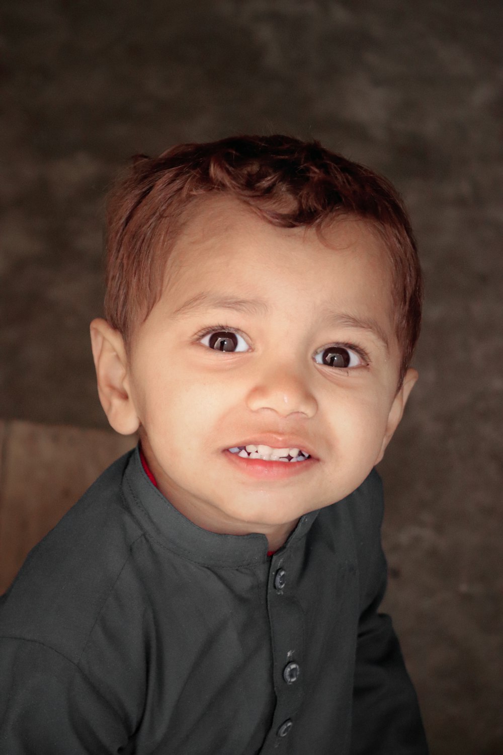 a boy smiling for the camera