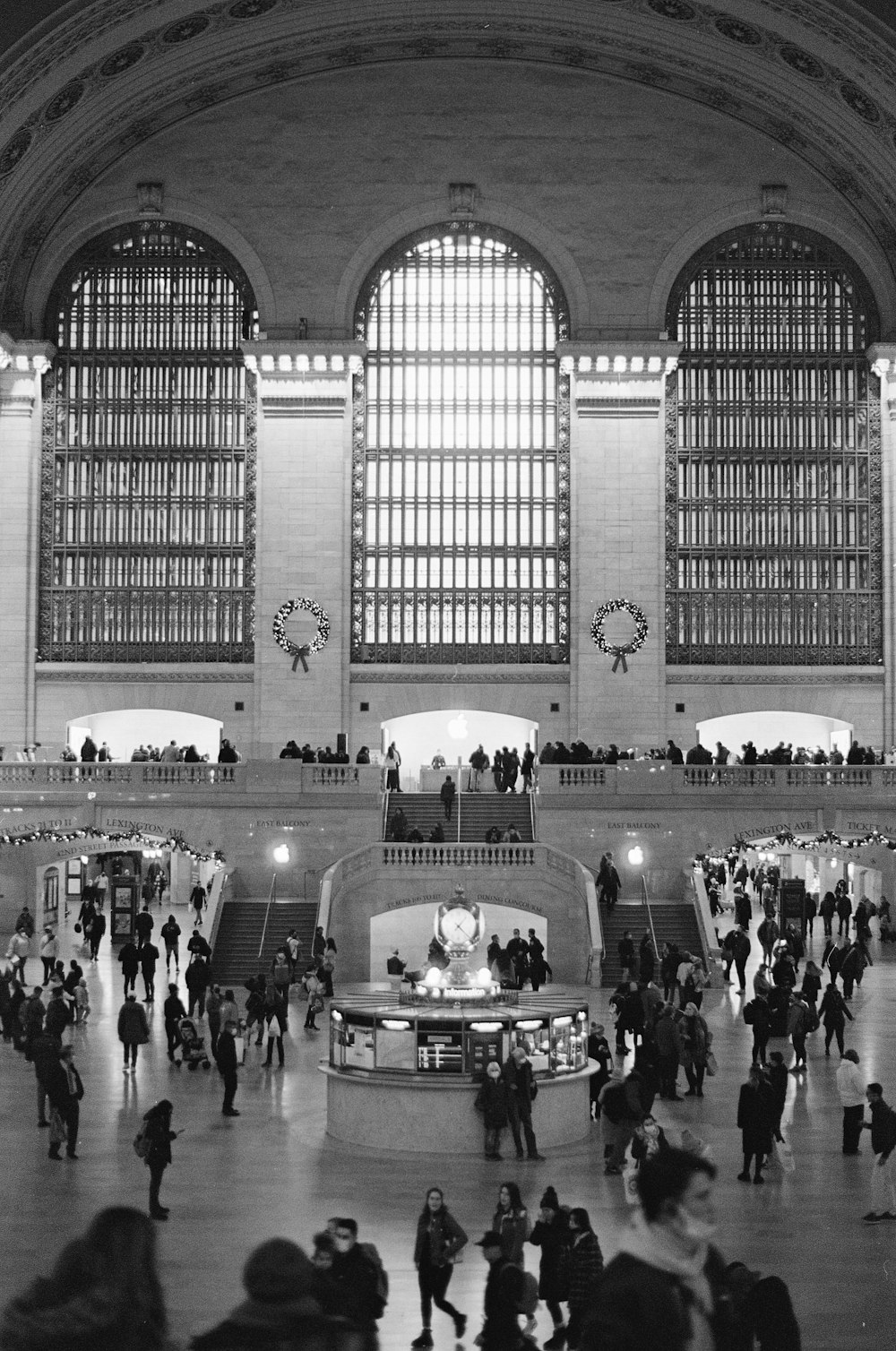 a large room with many people in it and large windows