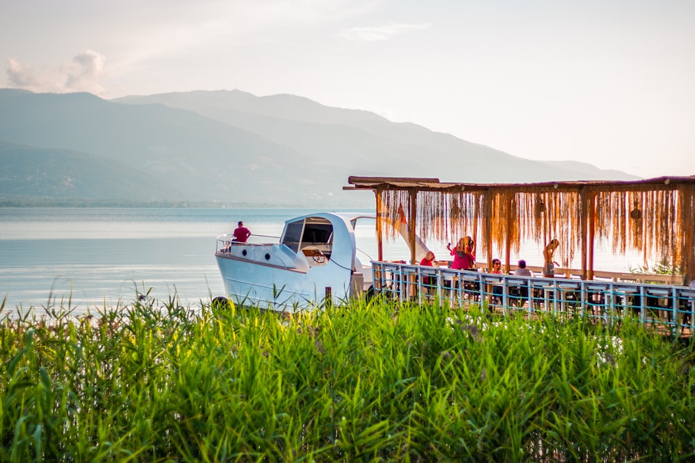 a boat is parked on the side of a pier