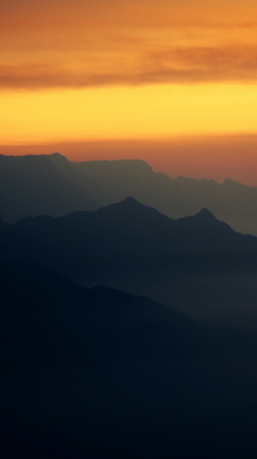 a sunset over a mountain range