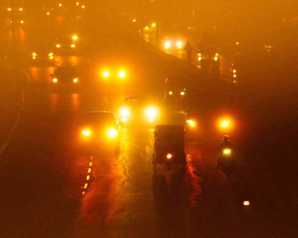a group of cars on a road at night