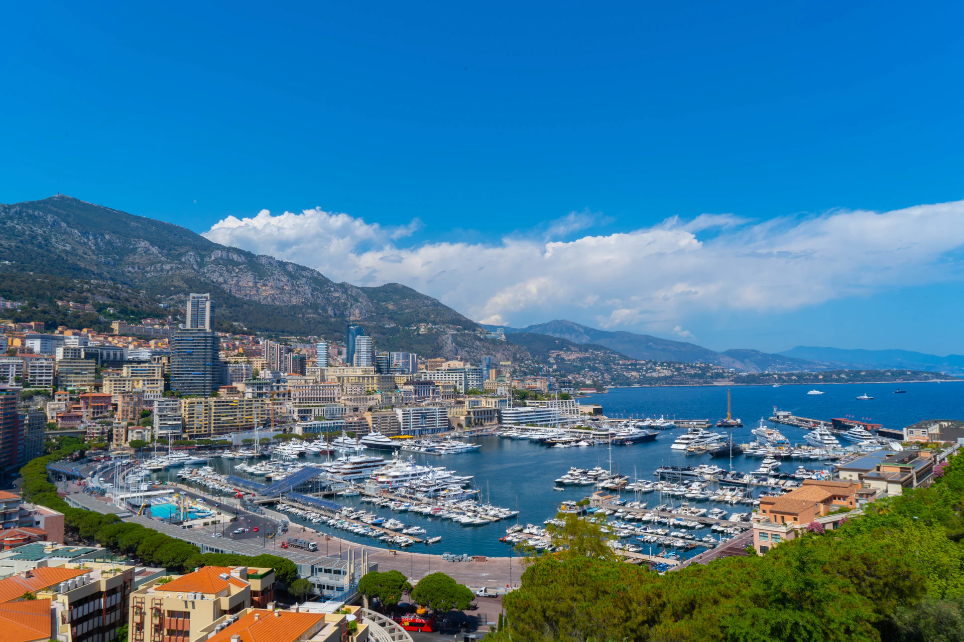 a city with boats in it and mountains in the background