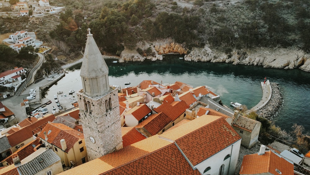 a large building with a tower by a body of water