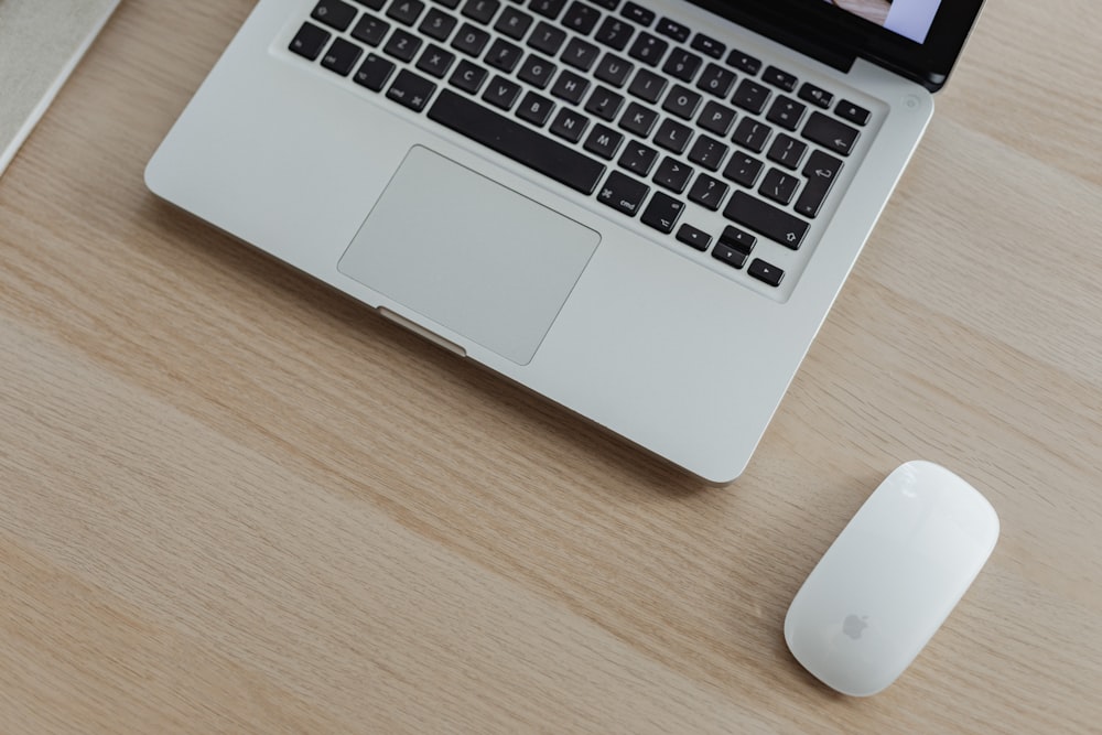 a laptop and mouse on a table