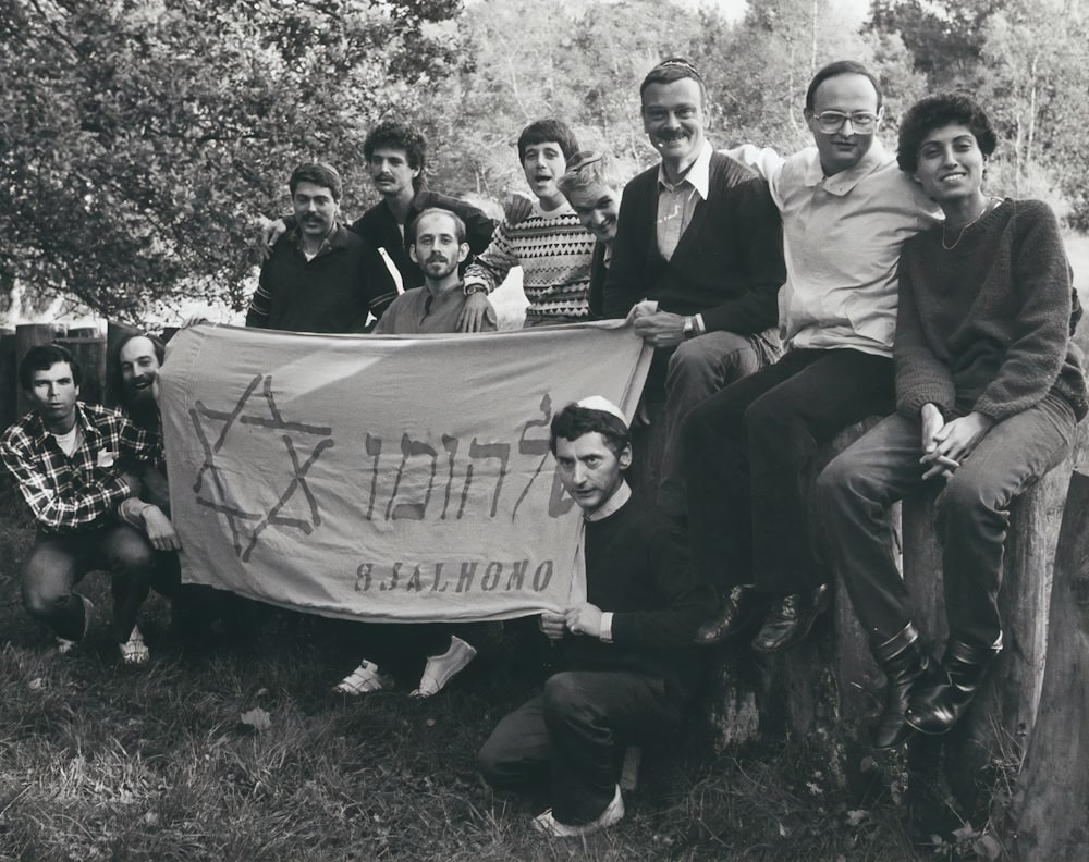 a group of people holding a sign