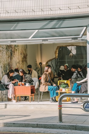 a group of people sitting outside a building
