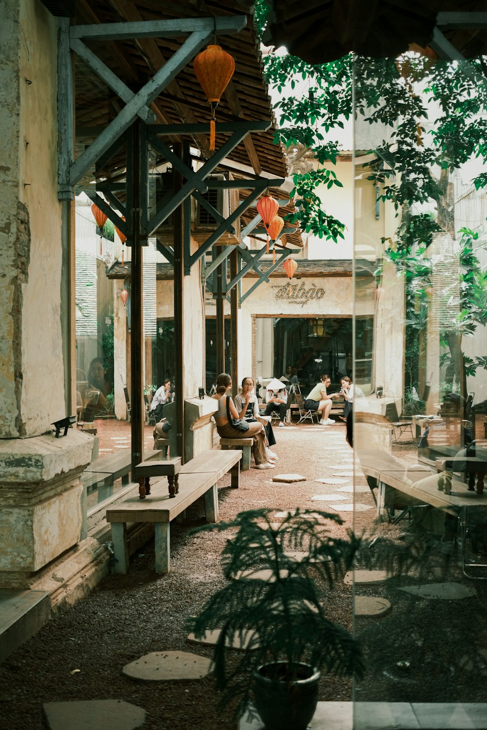 people sitting on benches outside a building