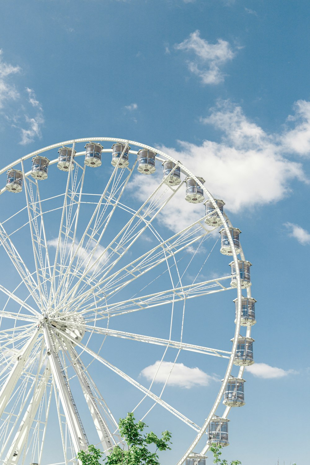 a ferris wheel with blue sky and clouds