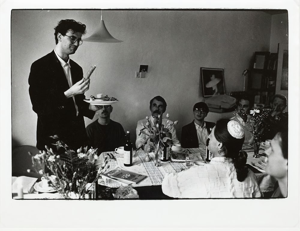 a group of people sitting around a table